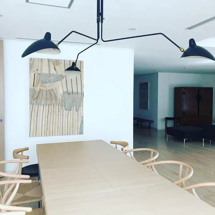Designer industrial chandelier illuminating a contemporary dining space