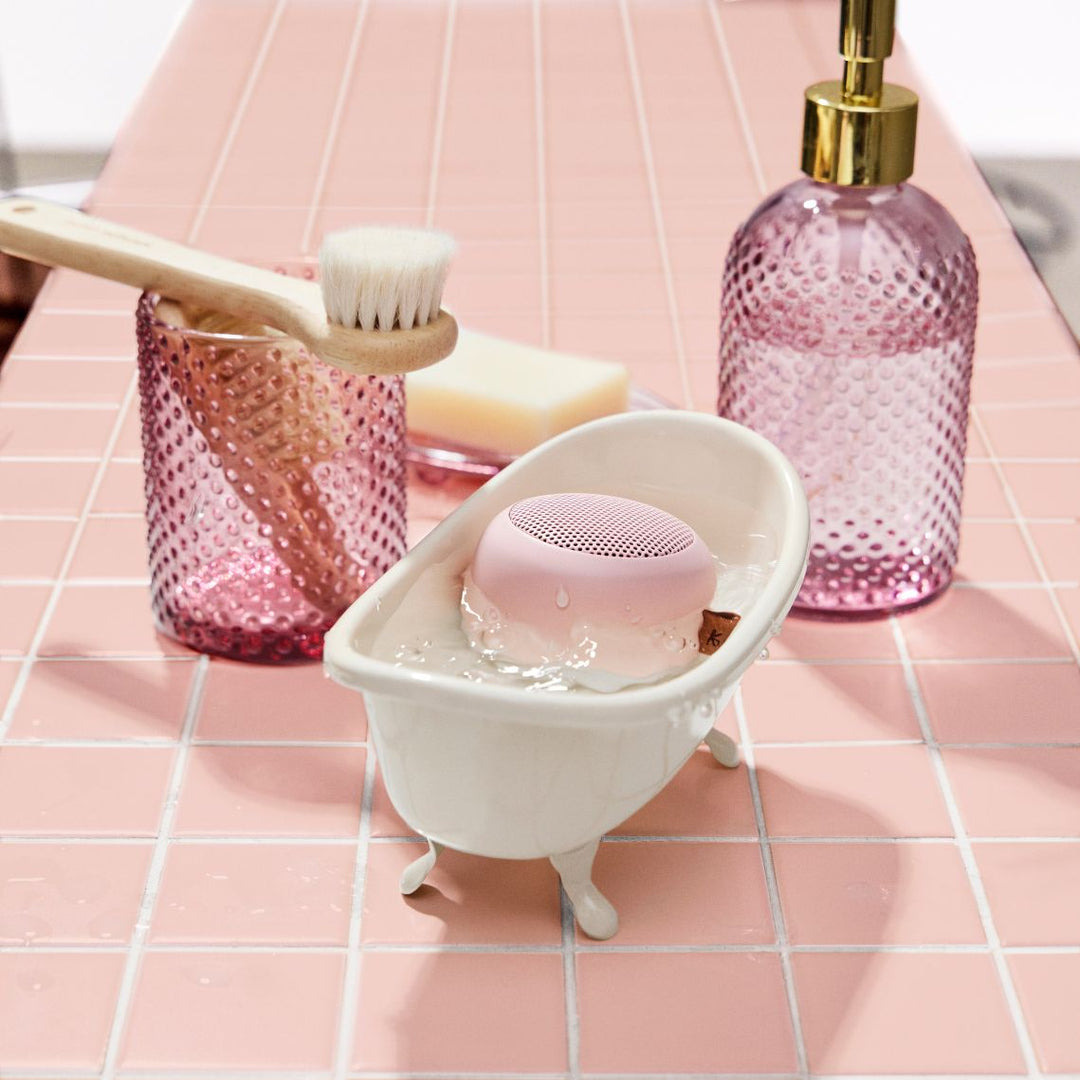 Wireless Bluetooth speaker resting safely on a wet bathroom vanity surface