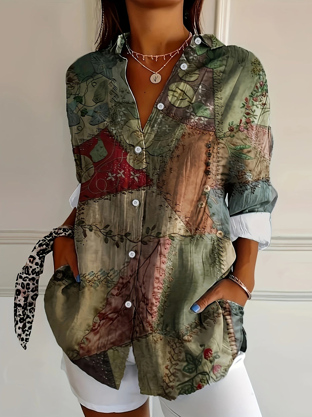 Woman wearing a vintage graphic print button-up top with V-neckline