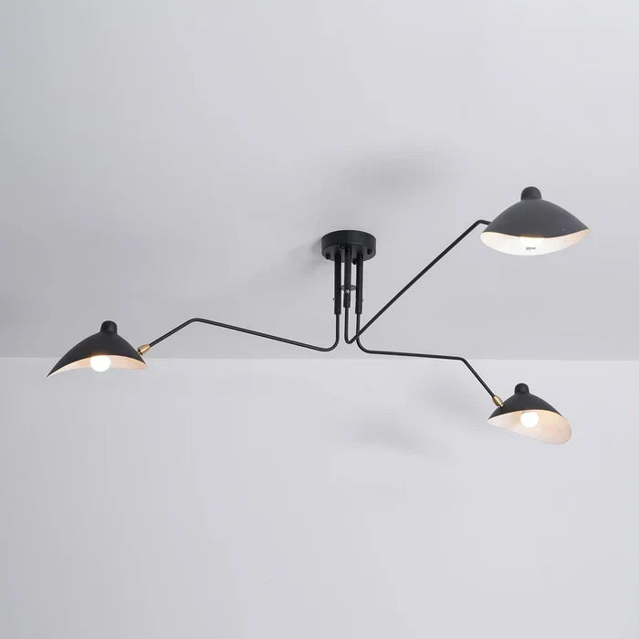 Full view of the modern swivel arm ceiling light in a styled room