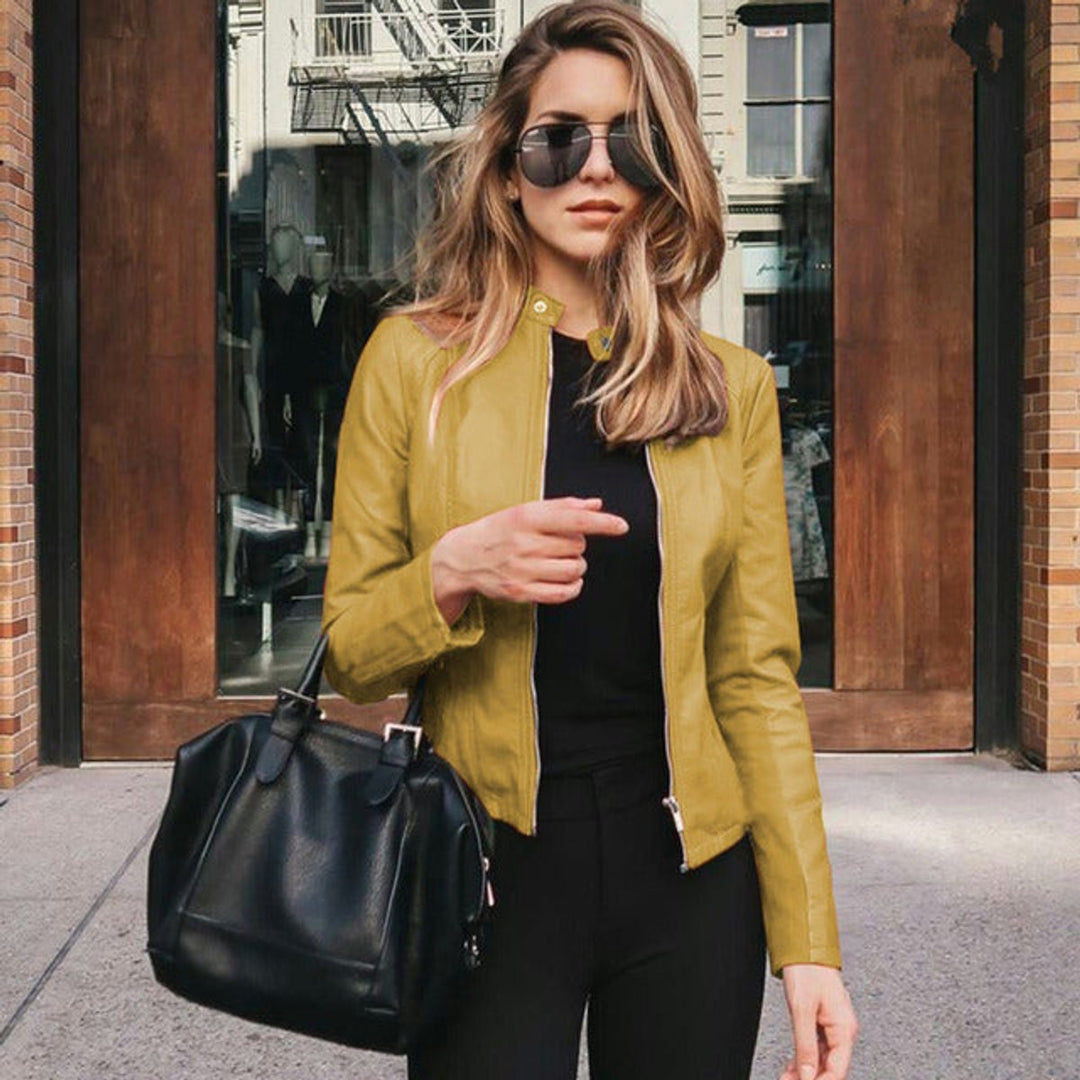 Woman wearing a yellow slim-fit biker jacket with urban background