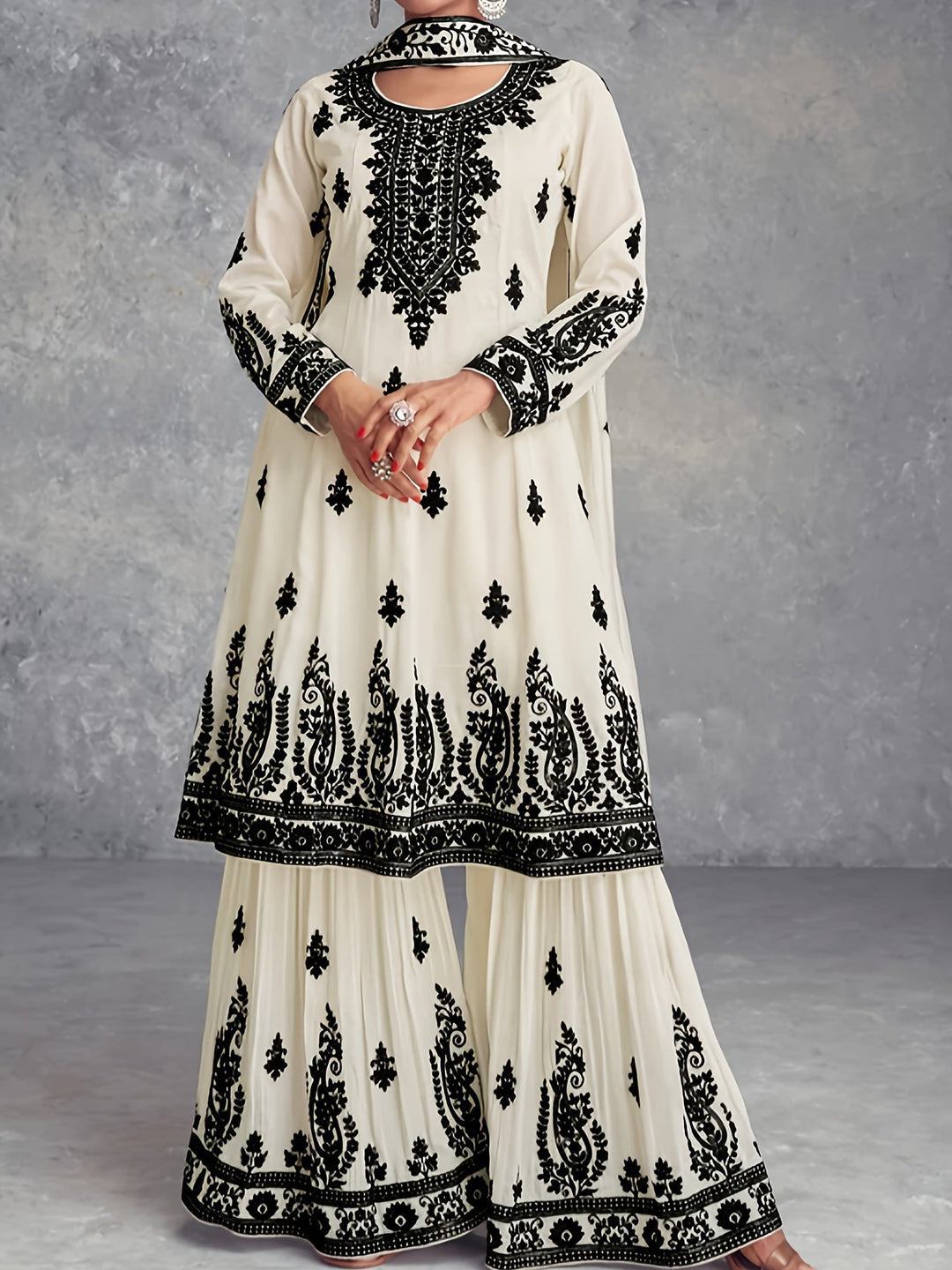 Front view of a woman wearing the ivory white printed two-piece set with detailed embroidery