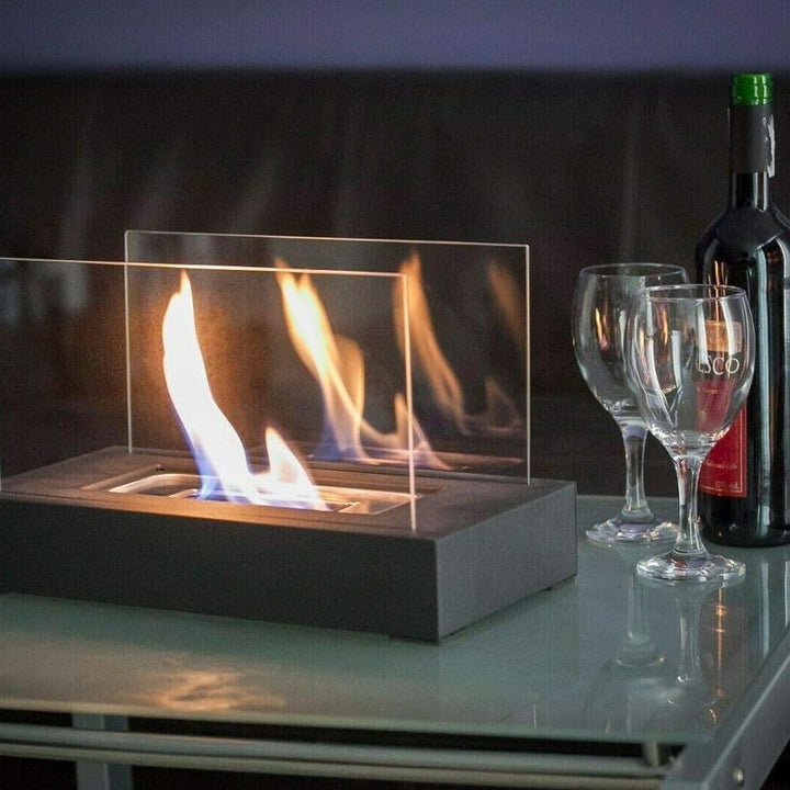 Modern tabletop bio-ethanol fireplace burning brightly on an outdoor patio table