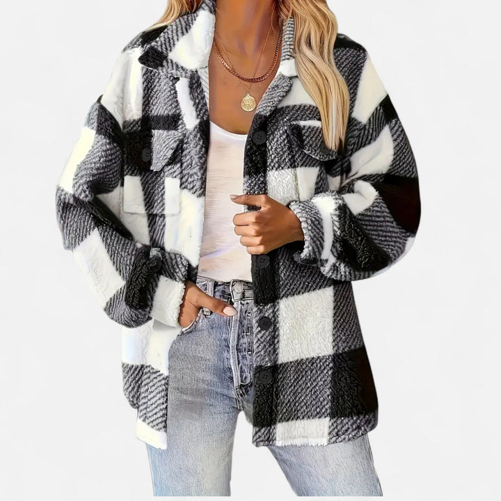 Woman wearing a black and white plaid oversized shacket with jeans