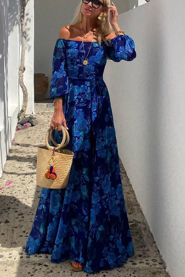 Front view of woman modeling the blue floral off-shoulder maxi dress