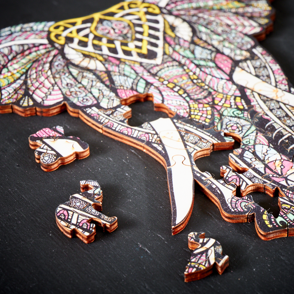 Close-up of textured wooden puzzle pieces shaped like animals