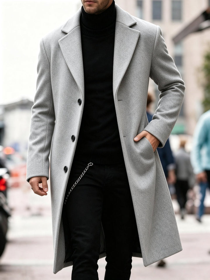 Back view of the navy men's long coat showing clean lines and tailored drape.