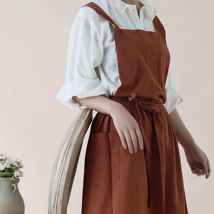 Rolled-up blue waterproof cooking apron ready for travel or gifting