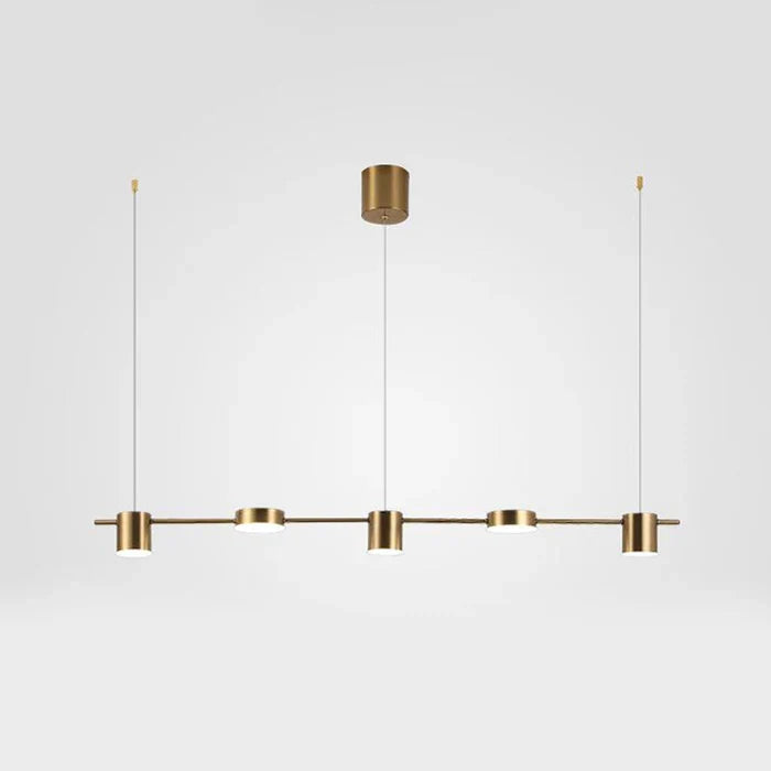 Modern aluminium pendant lamp hanging over a sleek minimalist dining table