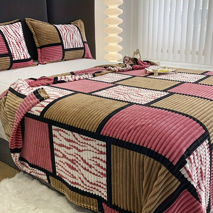 Comfortable soft blanket arranged artfully on a queen-sized guest bed