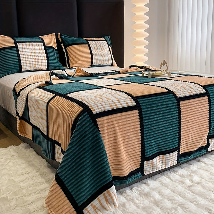 Green and beige checkered flannel blanket draped over a modern bed