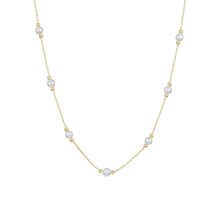 Elegant gold pearl necklace showcasing layered design and statement pendant for women.