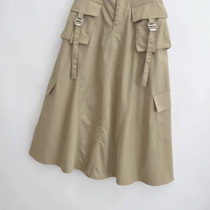 Close-up of cargo pockets and metal buckles on midi skirt