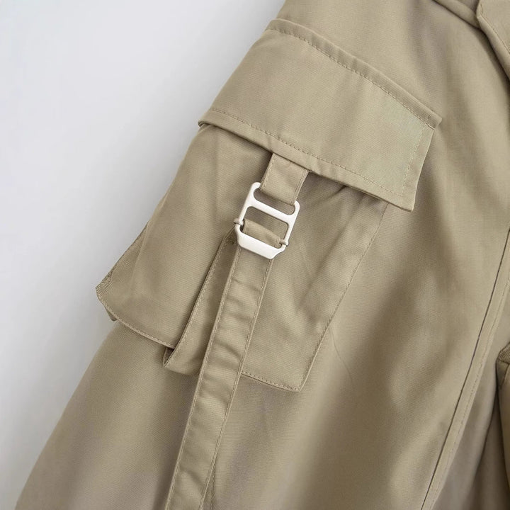 Detailed view of cargo pockets and stitching on khaki utility midi skirt