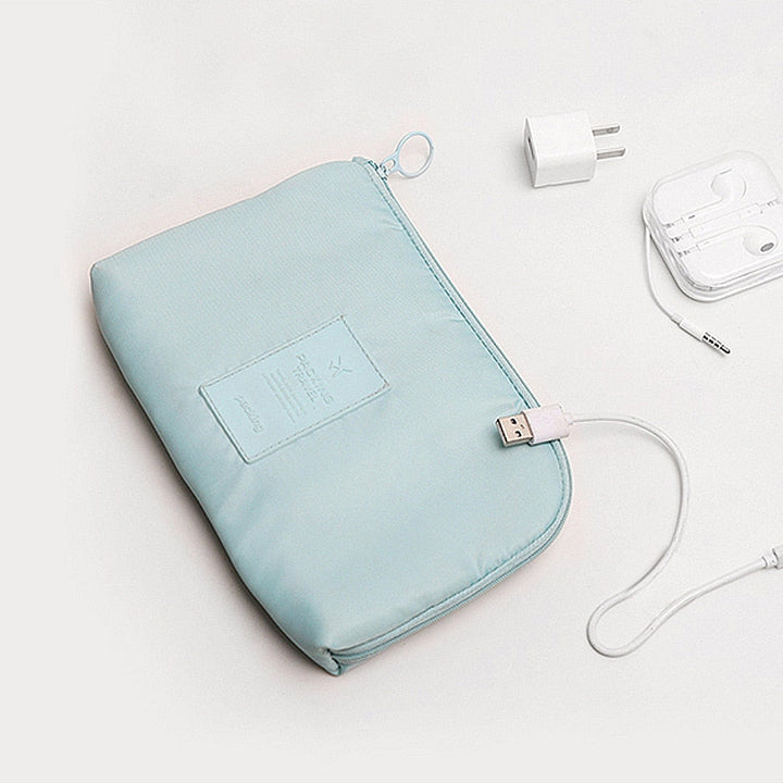 Compact electronics travel bag packed neatly with charging cables