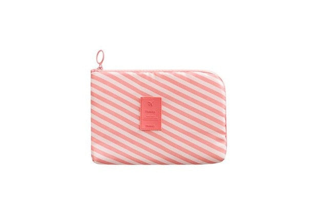 Portable storage bag holding phone cables, chargers, and SD cards