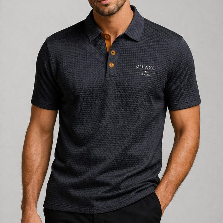 Man wearing dark grey textured knit polo shirt with spread collar