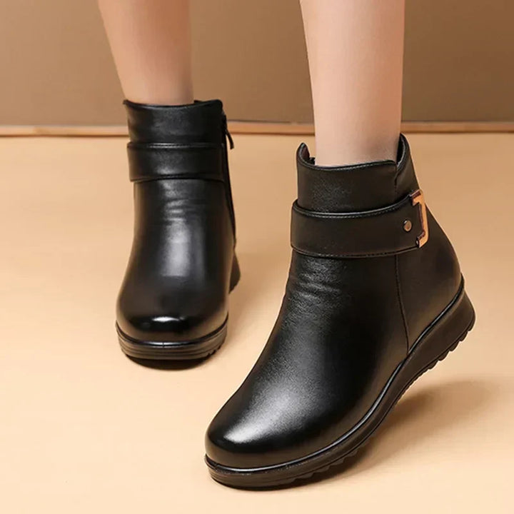 Front angle view of women's black winter boots showcasing the sleek design
