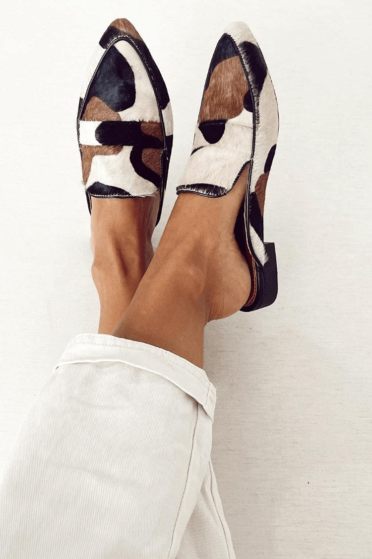 Women's abstract pattern loafers in black and white worn with casual trousers