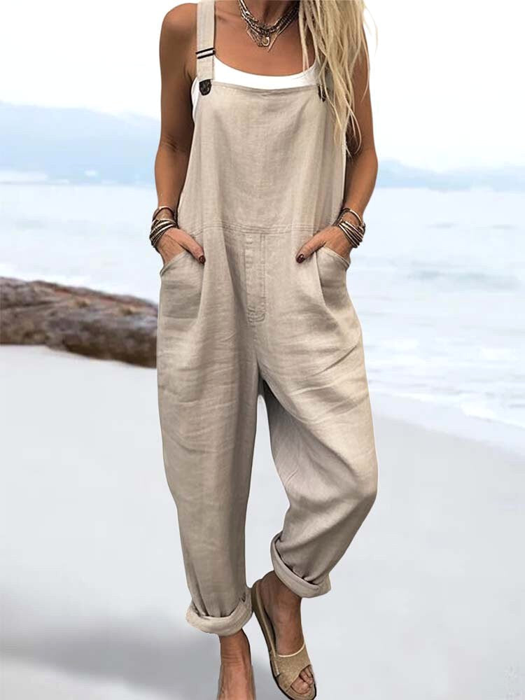 Woman wearing relaxed khaki linen overalls at the beach