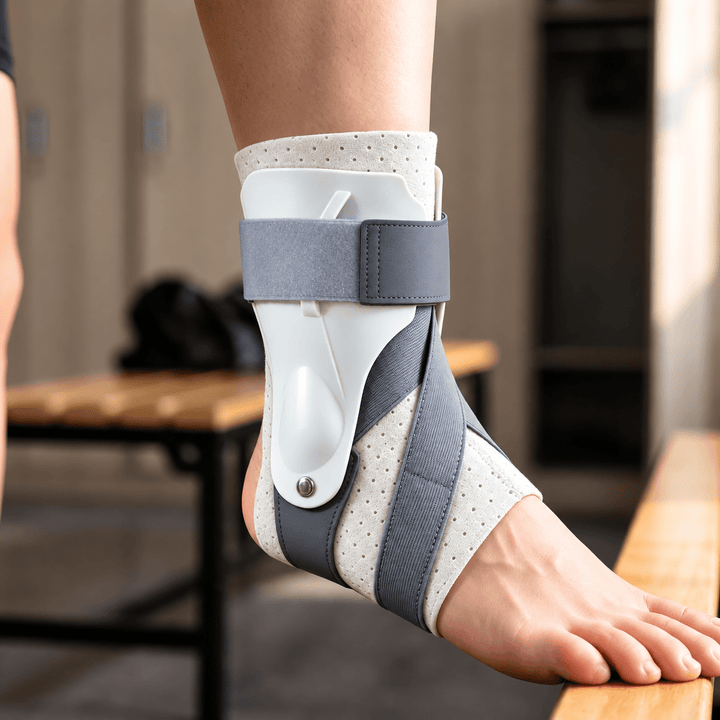 Gray white adjustable ankle brace worn on right foot featuring white side stays and compression straps
