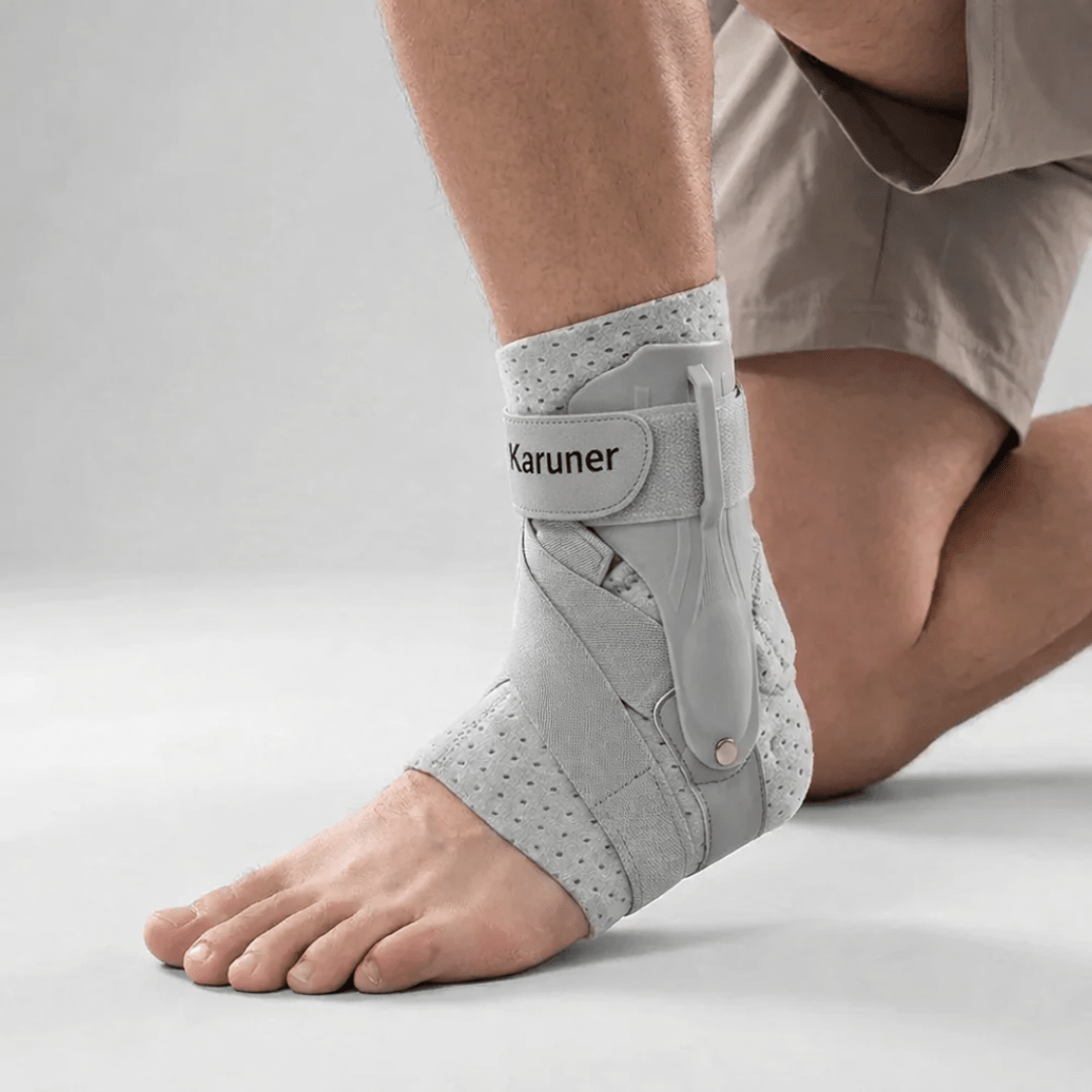 Side profile of a person kneeling while wearing the gray breathable compression ankle sleeve