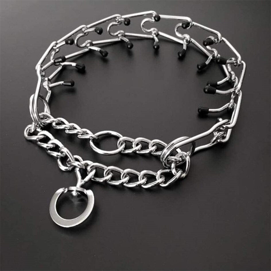 Adjustable dog training collar with rubberized prongs displayed on a dark surface