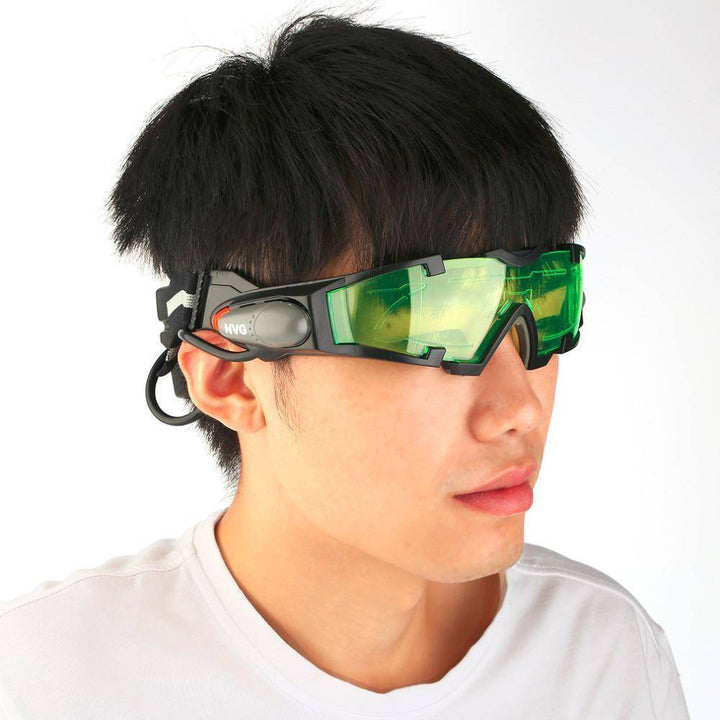 Person wearing adjustable night vision goggles with green tinted lenses