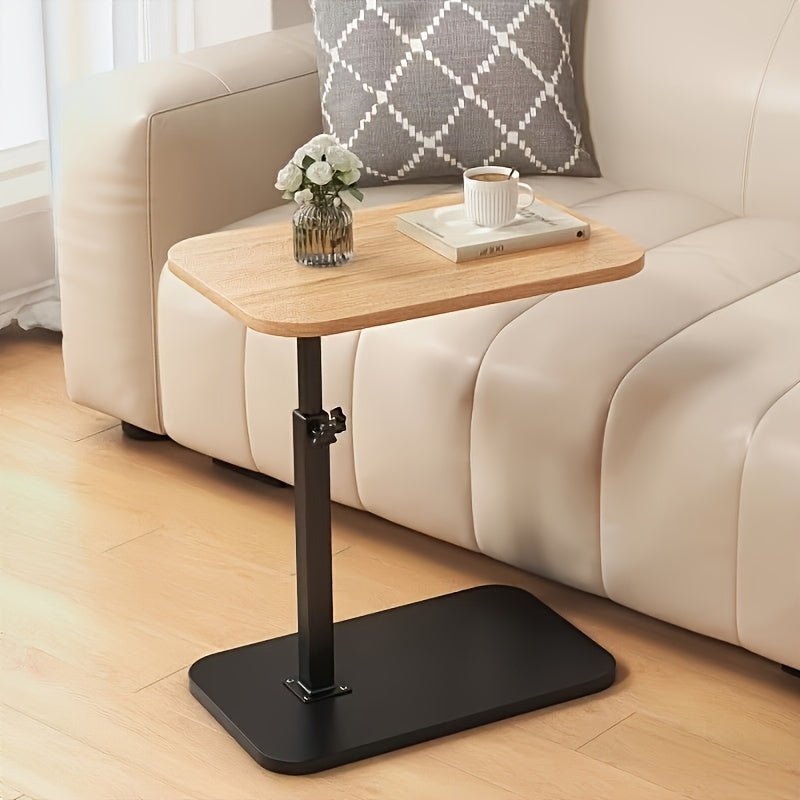 Living room furniture side table displaying a small lamp and book
