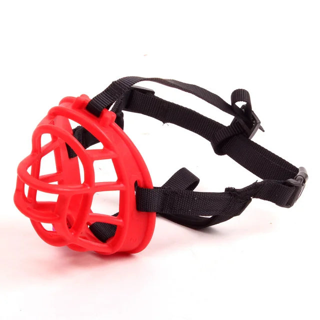 Red basket style dog muzzle with adjustable black straps on a white background