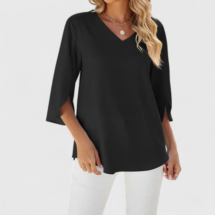 Office chic women's fashion blouse in a solid color with a flattering ruffle trim.