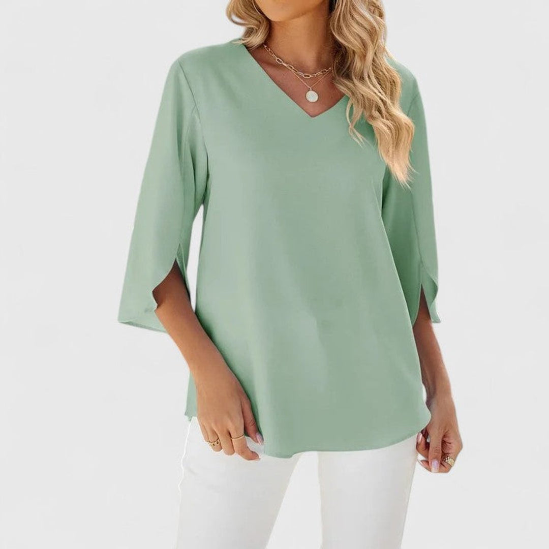 Charming V-neck shirt for women showcasing chic ruffle accents and 3/4 length sleeves.