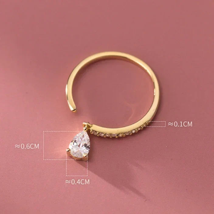 Womens gemstone ring with adjustable band worn delicately on a finger