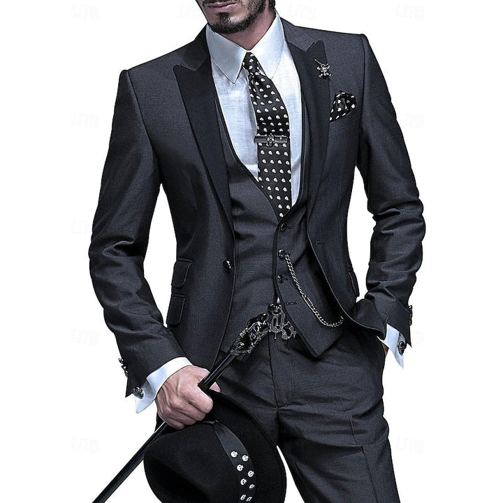 Man wearing a dark grey tailored three-piece suit with black lapels
