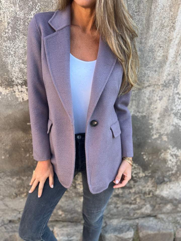 Stylish women's office wear blazer styled with a casual top