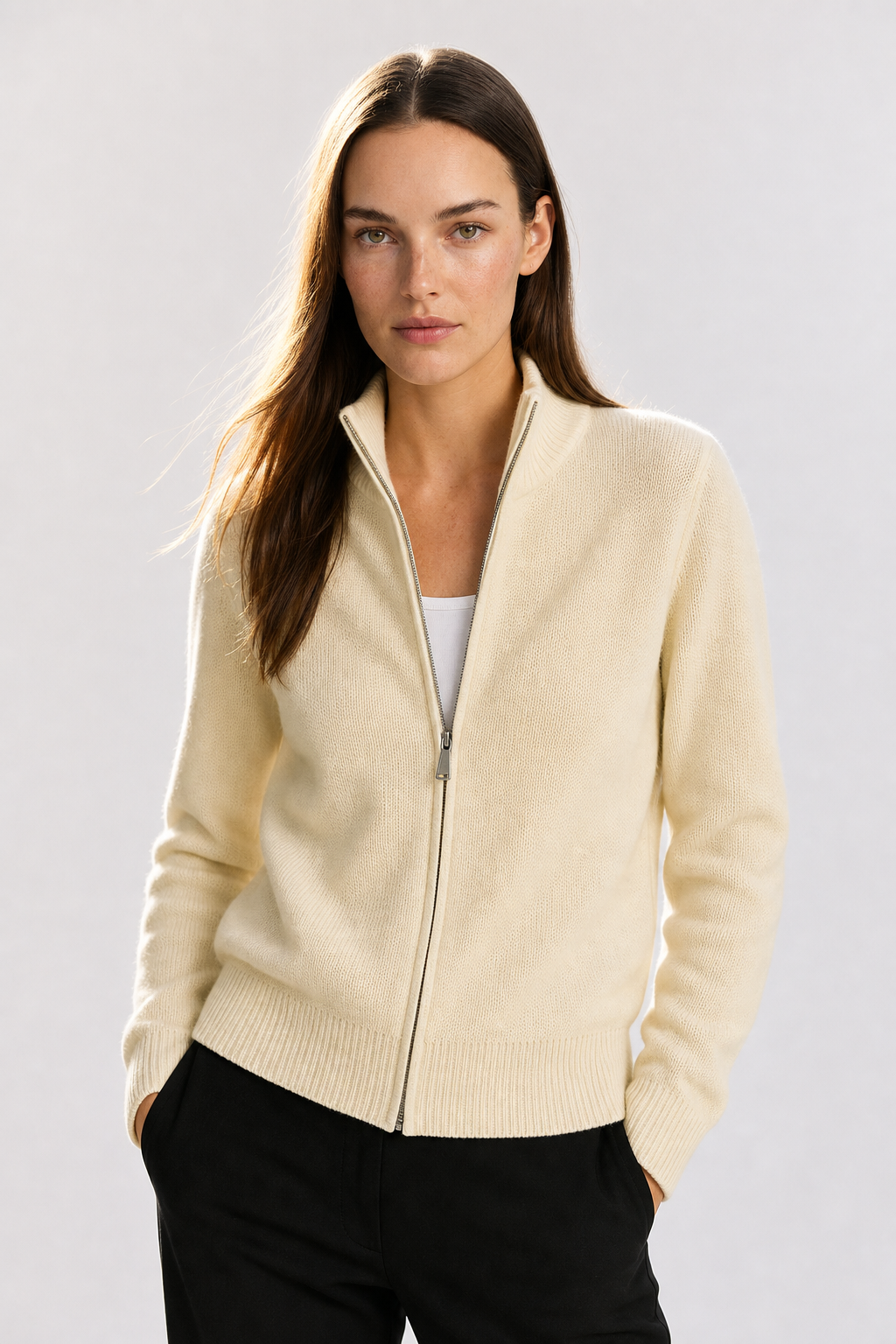 Woman wearing an ivory high-collar zip knit cardigan