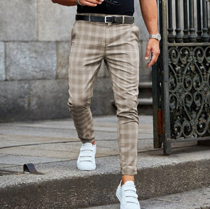 Man wearing beige check chinos with white sneakers outdoors