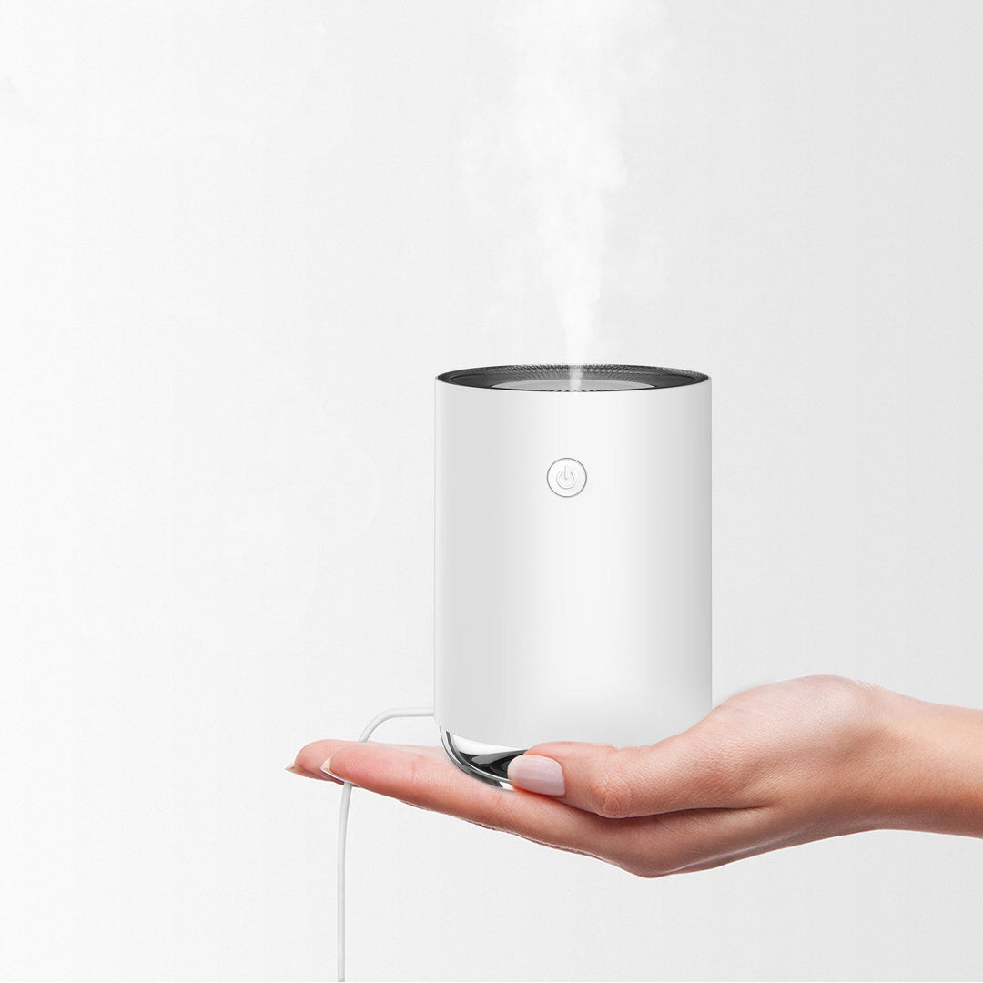 Ultrasonic diffuser and air humidifier releasing a fine hydrating mist for home wellness.