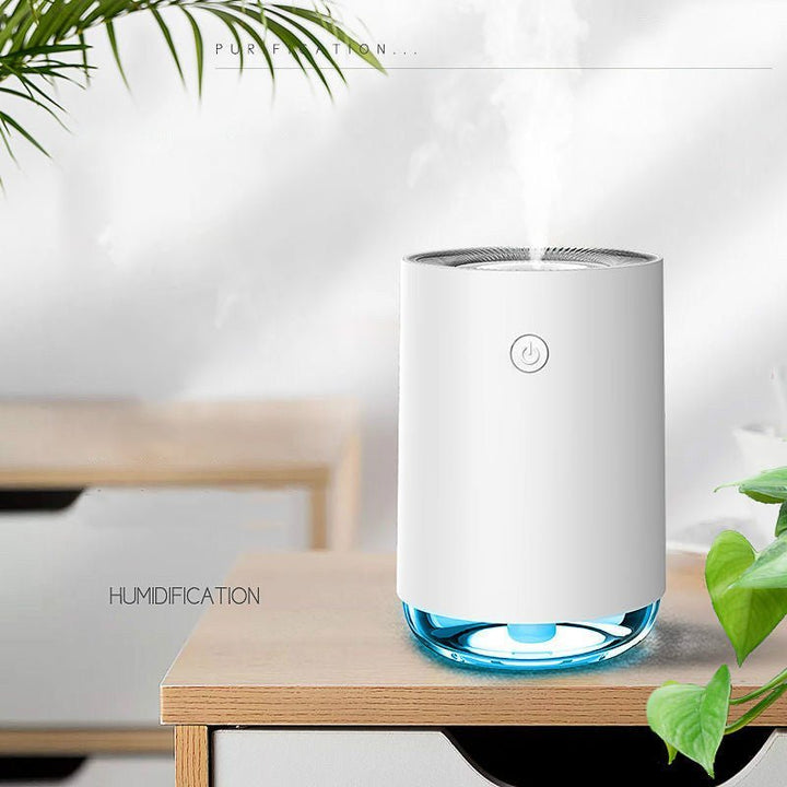 Modern compact diffuser sitting on an office desk next to plants