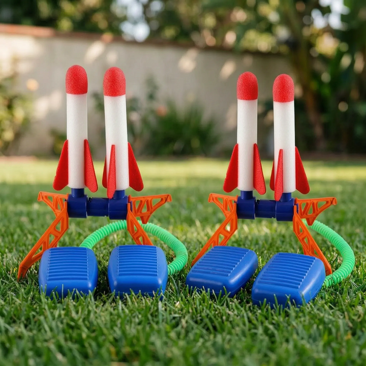 Multiple air-powered rocket launching sets displayed on a green lawn for outdoor group play