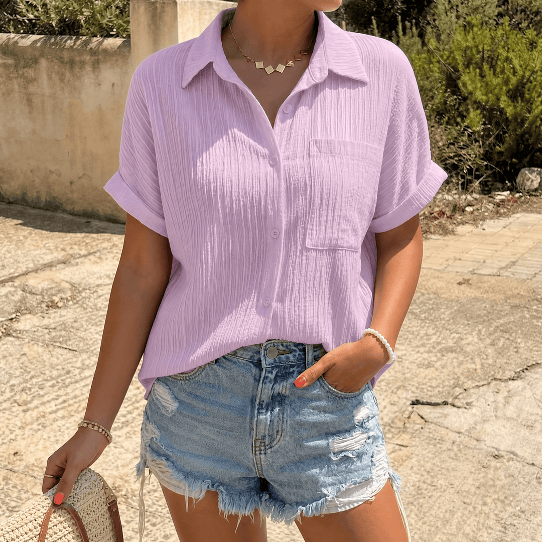 Full view of women's crinkle short sleeve blouse ready for summer