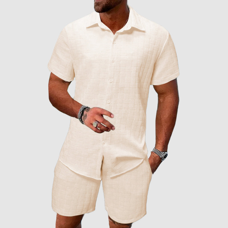 Man wearing beige short sleeve button down shirt and matching shorts set