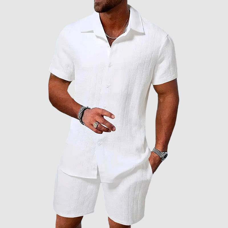 Man wearing white short sleeve button down shirt and matching shorts set