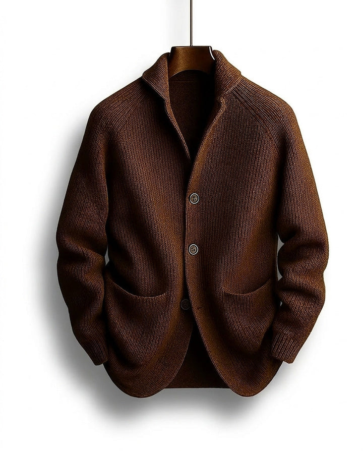 Brown knit cardigan with shawl collar and buttons hanging on a hanger