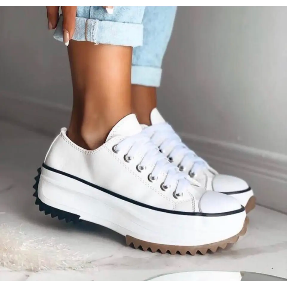 Close-up detail of mesh fabric and laces on women's casual platform sneakers