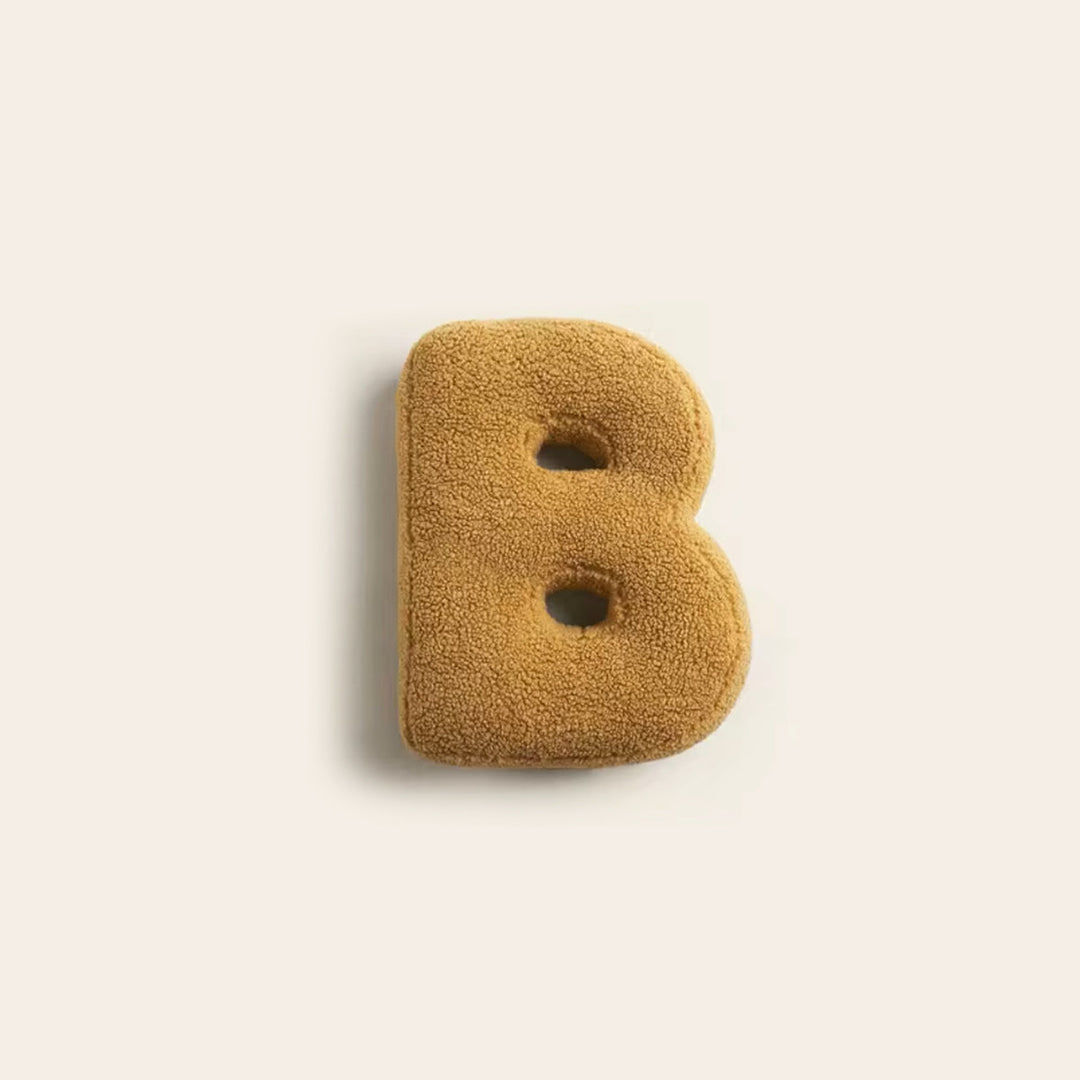 Single plush letter B decorative cushion in mustard yellow color