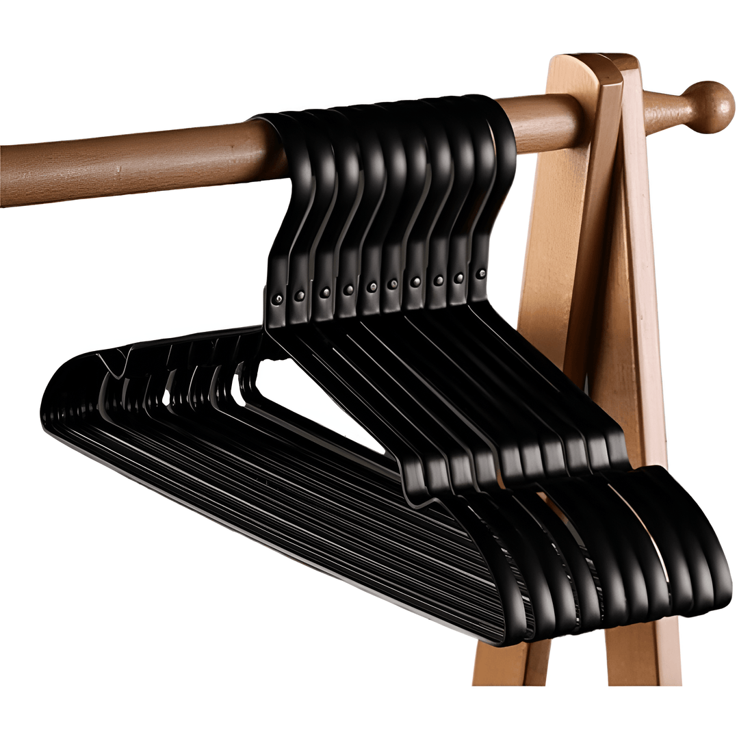 Stack of black aluminum clothes hangers hanging on a wooden rod