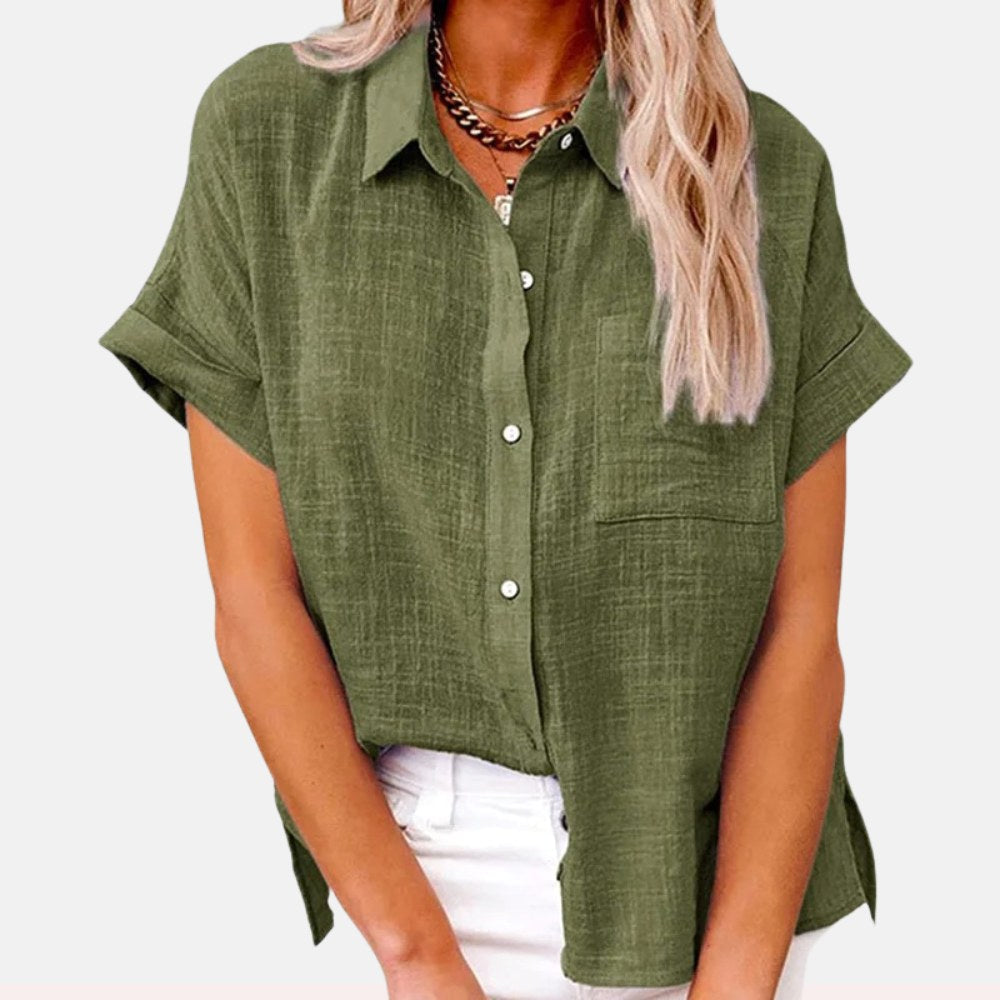 Woman wearing a green button-front short sleeve blouse