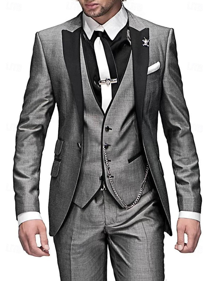 Man wearing a grey tailored three-piece suit with black lapel details