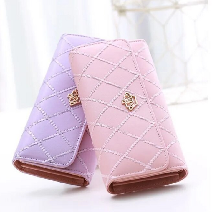 Zippered coin pocket open on the back of the women's argyle trifold wallet.